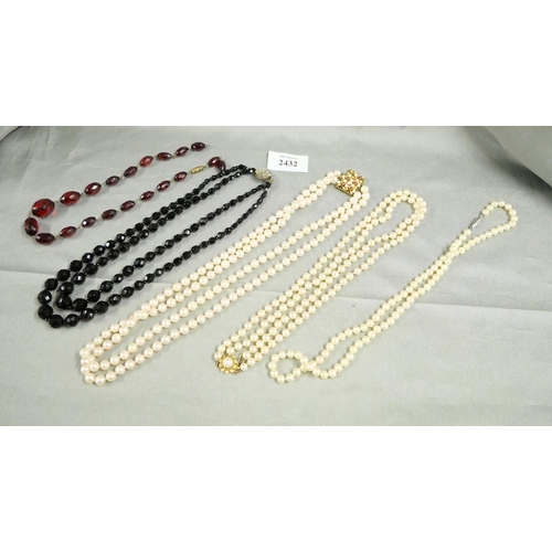 2432 - Case Containing 2 x Pearl Necklaces with 14ct Closures, Jetware & Amber Necklaces.