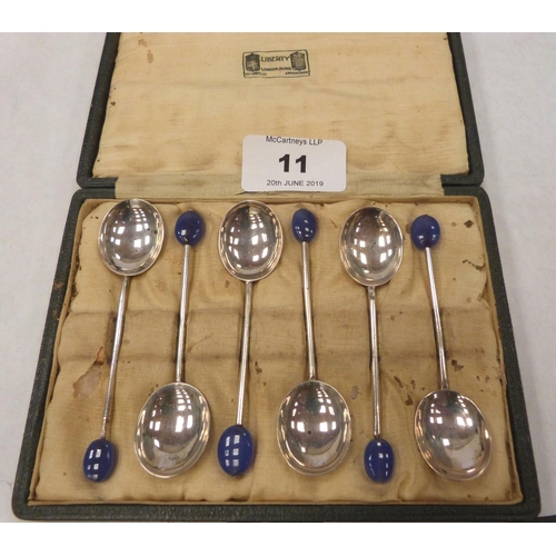 11 - A George V cased set of six silver coffee spoons with glass bean terminals. Liberty & Co. Birmingham... 