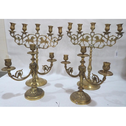 275 - A pair of east European five light candelabra, 15¾' high and a pair of smaller three light brass can... 