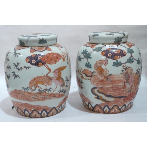 296 - A pair of 20th century Chinese jars and covers, painted with exotic birds and prunus. 12' high