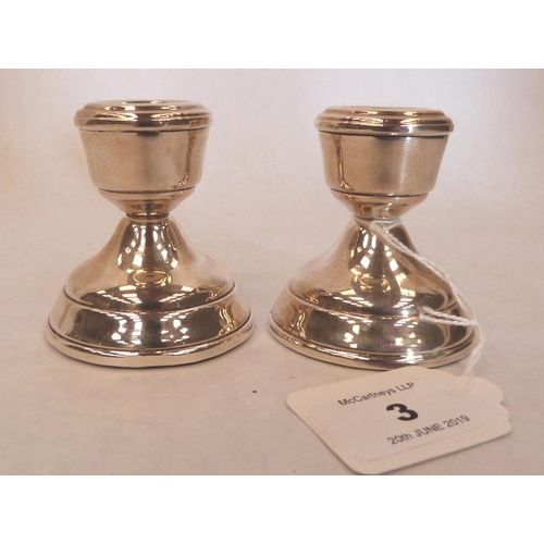 3 - A pair of Elizabeth II silver squat candlesticks, 2½' high. Birmingham 1971. Loaded