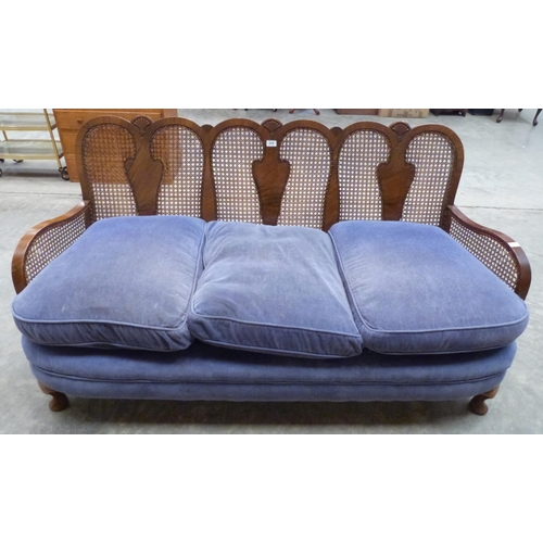 418 - A 1920s walnut triple chair back bergere sofa on cabriole legs