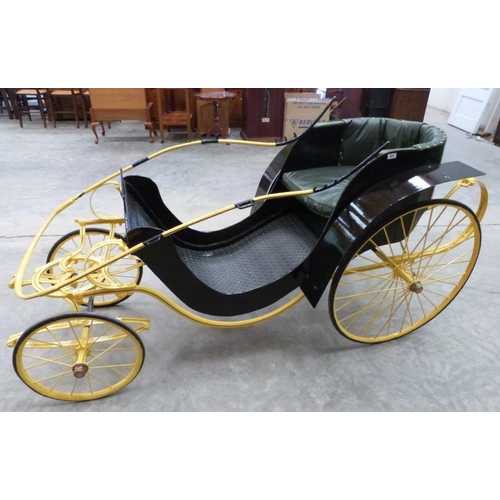 422 - A Victorian donkey carriage with black coachwork, yellow chassis and wheels, the seat upholstered in... 