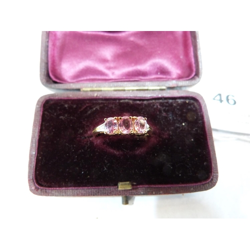 46 - A three stone pink tourmaline ring. In gold marked 750. Size Q. 2.7g gross