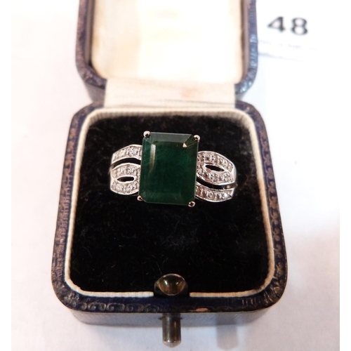 48 - An emerald and diamond ring. In white gold marked 375. Size S. 3g gross