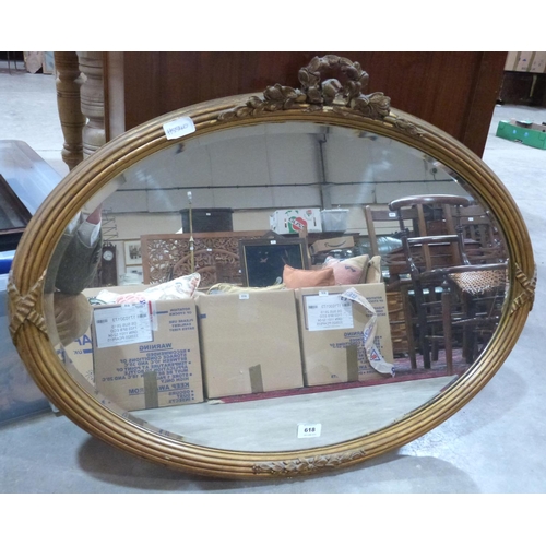 618 - A Victorian gilt gesso oval wall mirror with ribbon-tie reeded frame and foliate surmount, the bevel... 