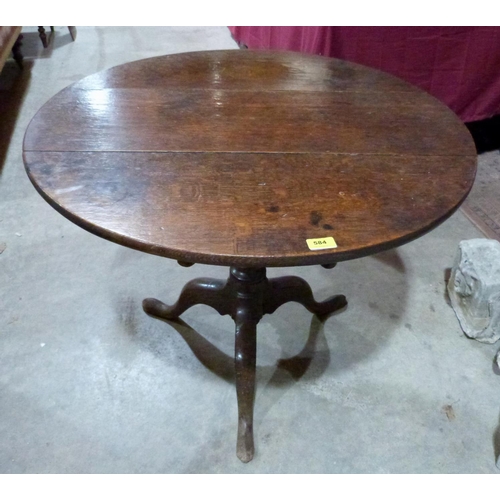 584 - A George III oak snap-top tripod table. 32½' diam