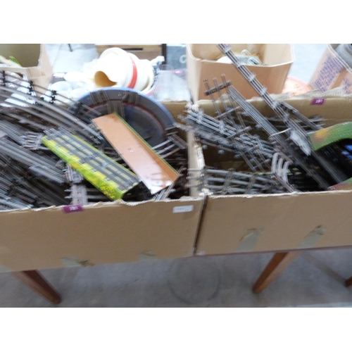 22 - Four boxes of playworn tinplate railway to include rolling stock, signals and track