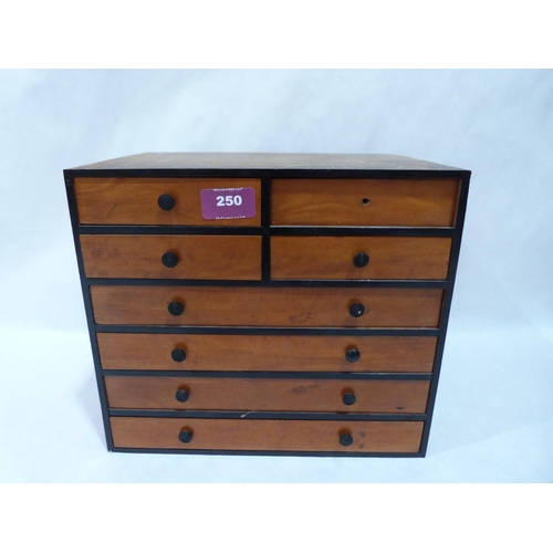 250 - A miniature  chest of eight drawers. 10' high