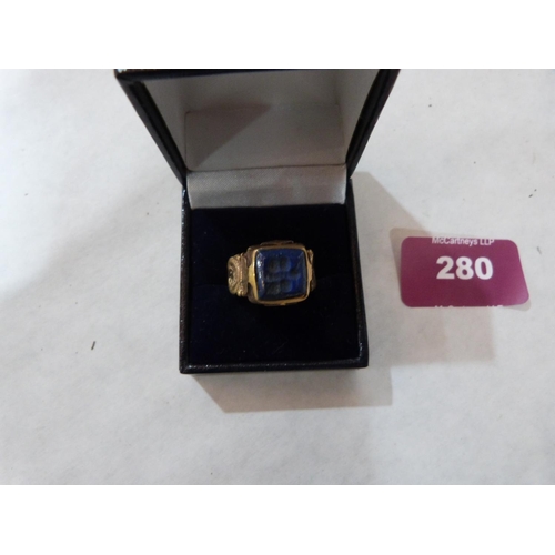 280 - An Islamic gilt metal blue stone intaglio ring. Size K½'