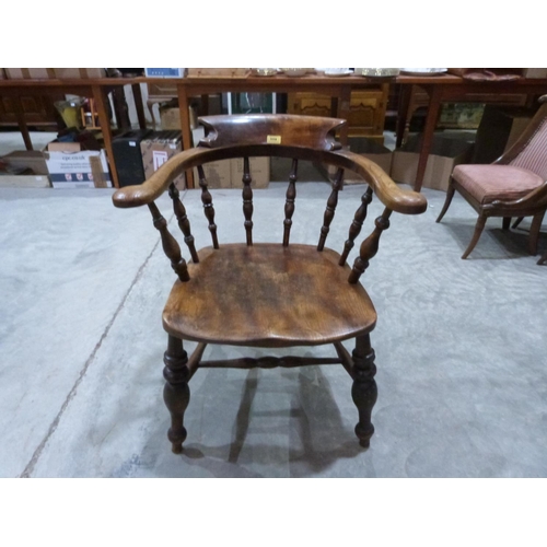 559 - A Victorian elm smoker's bow elbow chair