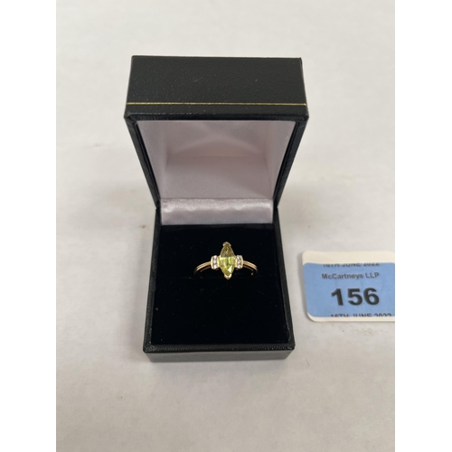 156 - A peridot and diamond ring. In gold marked 750. 3.7g gross. Size N