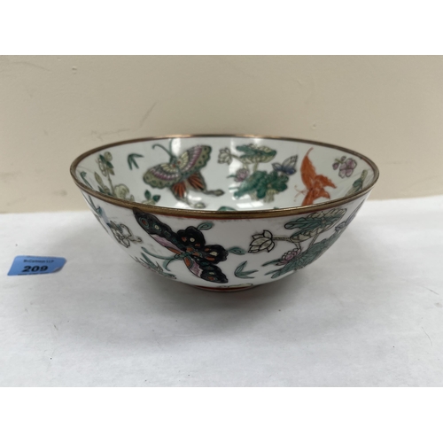 209 - A Chinese famille-rose bowl, decorated with foliage and flying insects. Tongzhi character mark to ba... 