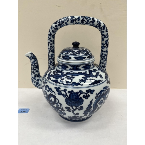 234 - A Chinese blue and white decorated teapot. 12' high. Crack to handle