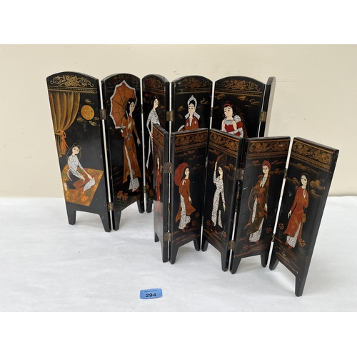 294 - An oriental six-fold lacquer table screen 13¾' high and a smaller five-fold example