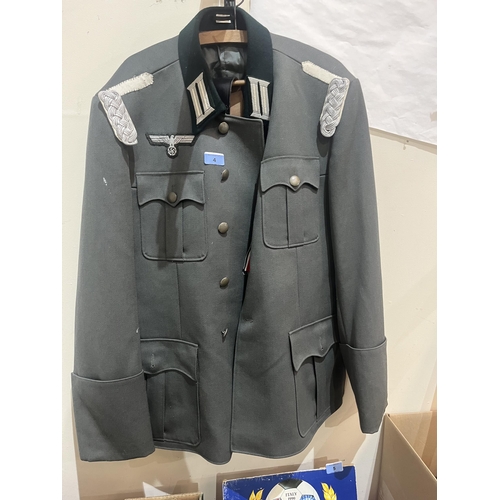 4 - A box of militaria to include a facsimile German jacket and cap