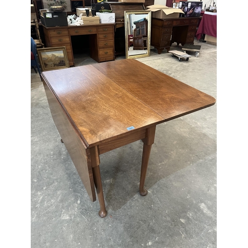 429 - A dropleaf table on turned tapered legs with pad feet. 42' wide