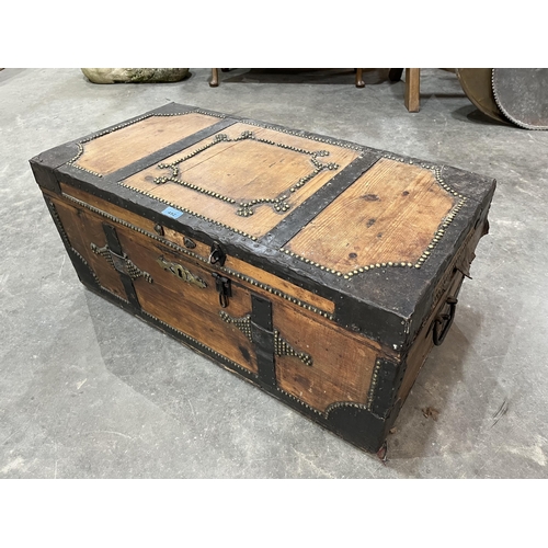 452 - An eastern pine and iron bound chest with brass domed nail decoration. 36' wide