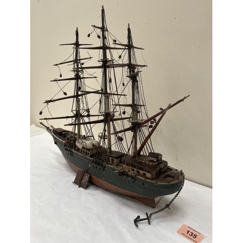 135 - A scratch-built carved wood and painted model of a three masted ship, fully rigged. The hull 21' lon... 