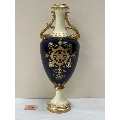 139 - A Coalport inverted baluster vase, richly gilded and painted in enamels with a hilltop castle in res... 