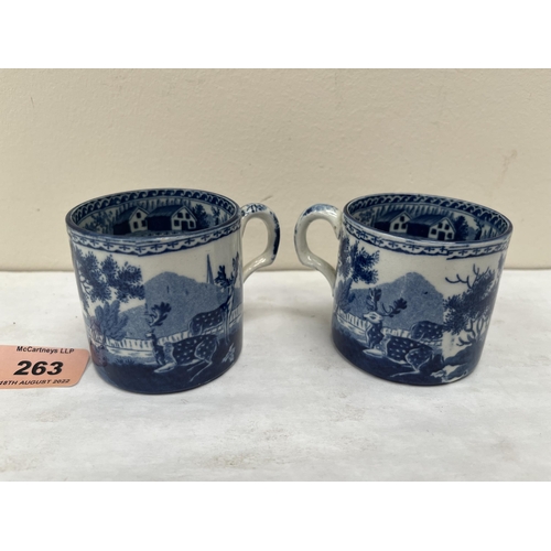 263 - A pair of early 19th century pearlware coffee cans, blue and white transfer printed with deer in a l... 