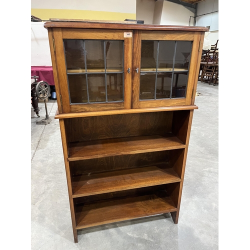 365 - A walnut bookcase enclosed by a pair of leaded glazed doors over three open shelves. 31' w x 52' h