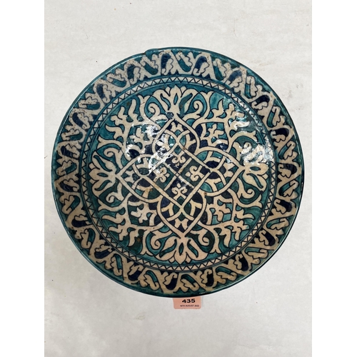 435 - An Iznik style glazed pottery bowl with geometric decoration. 11¼' diam.