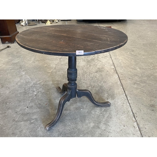 490 - A 19th century oak tripod table. 30' diam. (A.F.)