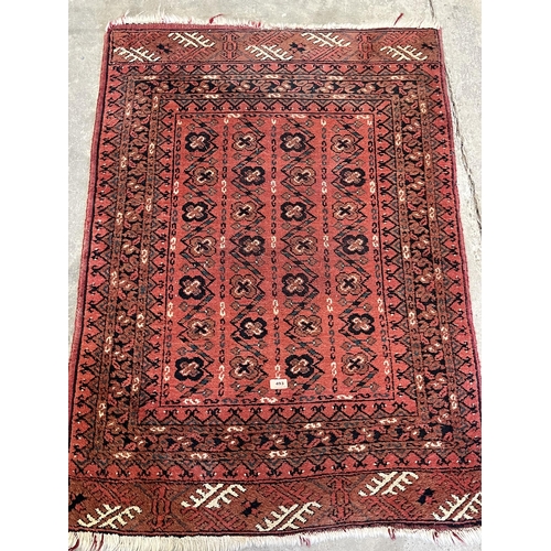 493 - A red ground eastern rug. 51' x 36'