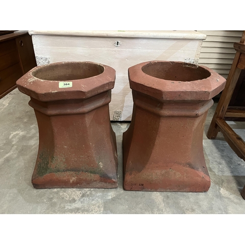 384 - A pair of terracotta chimney pot planters. 17½' high