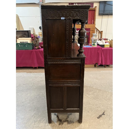 415 - A 17th century joined oak court cupboard with carved cornice raised on turned pilasters flanking a p... 