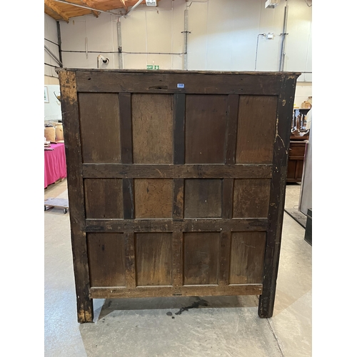 415 - A 17th century joined oak court cupboard with carved cornice raised on turned pilasters flanking a p... 