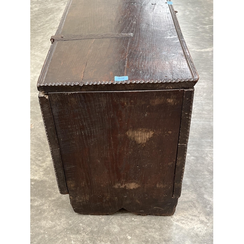 416 - A late 17th century oak six plank chest, with chip carved decoration, the channel moulded lid enclos... 