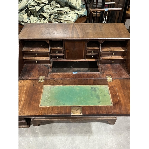 453 - An 18th century and line inlaid writing bureau, the sloping fall enclosing a fitted interior over tw... 