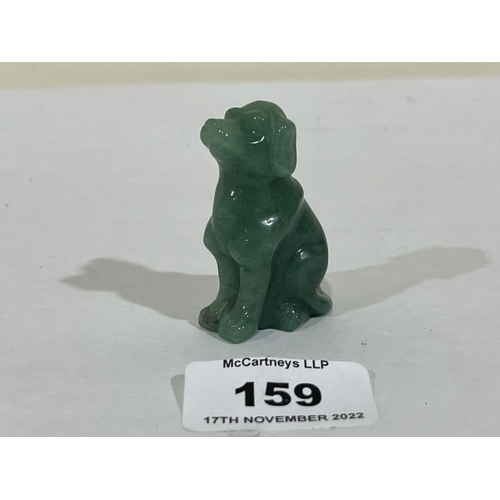 159 - A carved jade seated dog. 2' high