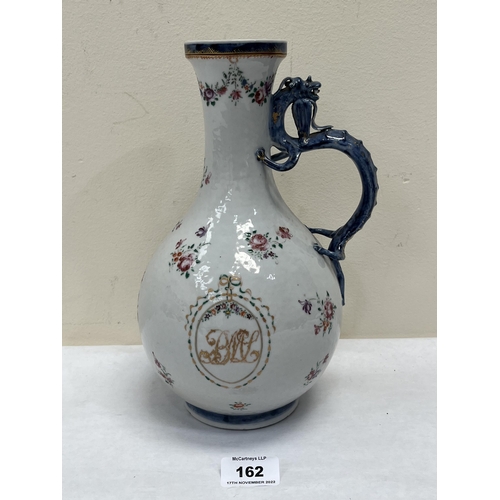 162 - An 18th century Chinese export famille-rose ewer with sinuous dragon handle, painted with scattered ... 