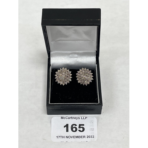 165 - A pair of 18ct diamond cluster earrings, the point 5 stones untreated. Each earring 15mm diam.