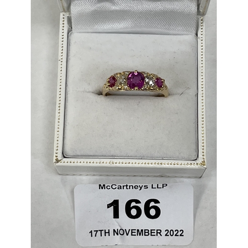 166 - An early 20th century 18ct ring set with two old cut diamonds, three rubies and eight diamond chips.... 