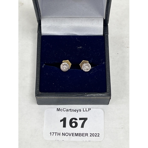 167 - A pair of 18ct white gold diamond stud earrings, each set with a point 10 stone. 1.85g gross