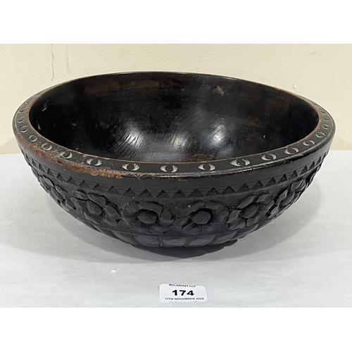 174 - An antique carved treen bowl. 11¾' diam.