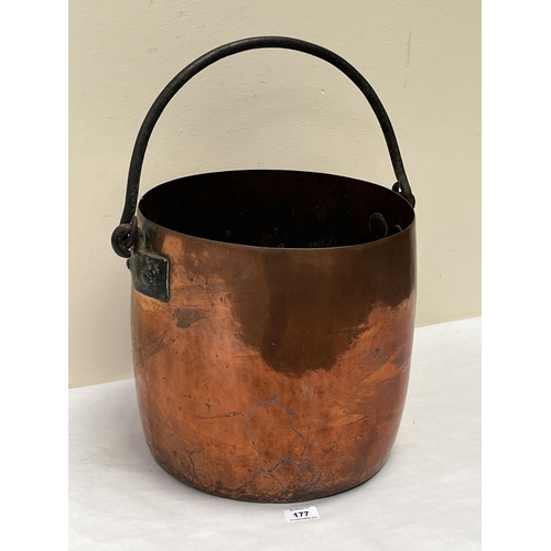 177 - A Victorian copper bucket with iron swing handle. 12¼' high excluding handle. Split to base rim