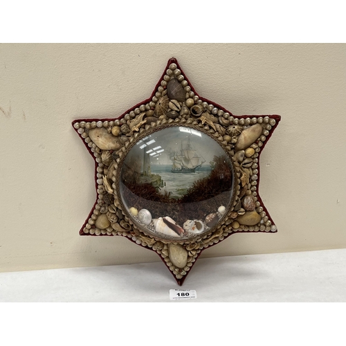 180 - A 19th century sailor's shellwork Valentine, of star form, with shells, seaweed and harbour scene be... 