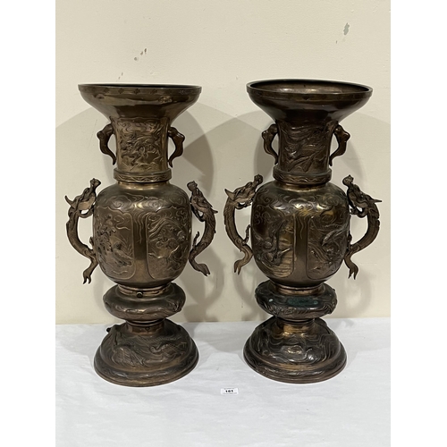 181 - A pair of Oriental bronze dragon vases. 24¾' high