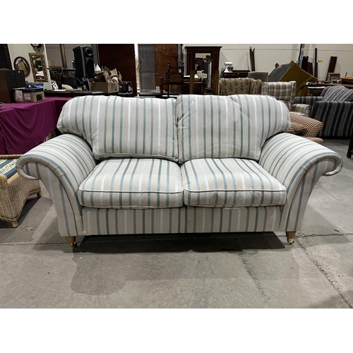 A Laura Ashley sofa upholstered in a striped fabric. 78' wide