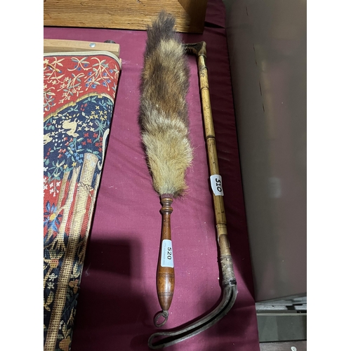 520 - A riding crop and a fox tail brush