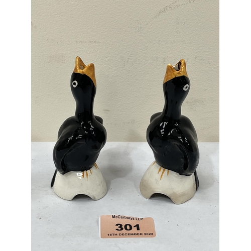 301 - A pair of Newport (Clarice Cliff) blackbird pie funnels. (One repaired)