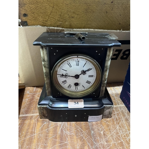 34 - A French slate and marble cased mantle timepiece with brass drum movement. 8' high