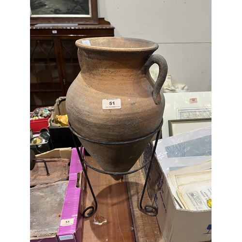 51 - A terracotta urn in wirework stand and two terracotta wall sconces