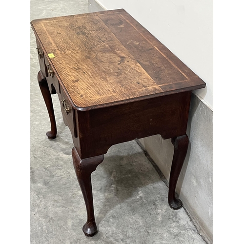 395 - An 18th century English provincial oak lowboy with herringbone banding, the moulded top over three d... 