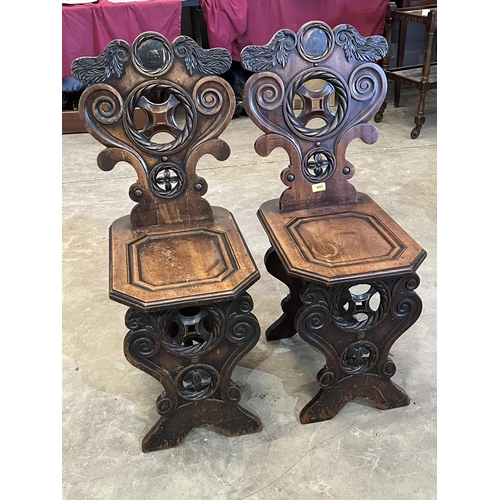 445 - A pair of 19th century 'Sgabello' Renaissance style hall chairs with shaped and pierced scroll carve... 